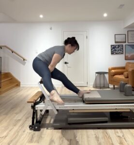 Reformer Tendon Stretch exercise with leg to side. Advanced Reformer repertoire. 